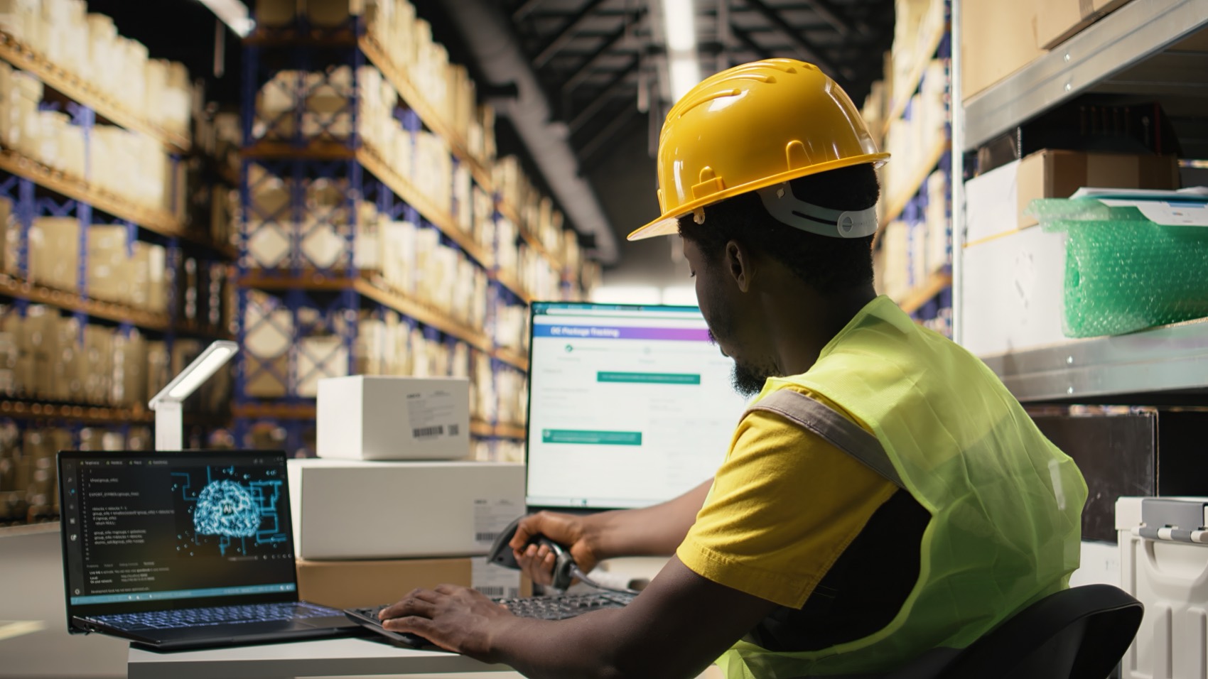 An operator scanning cargo with a tracking screen